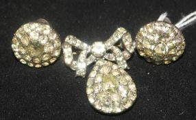 A 1930's paste set silver demi parure, comprising a brooch and pair of ear clips.