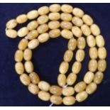 A single strand amber bead necklace, gross 53 grams, 84cm.