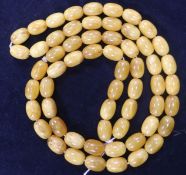 A single strand amber bead necklace, gross 53 grams, 84cm.