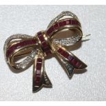 A 9ct gold ruby and diamond set ribbon bow brooch, 27mm.