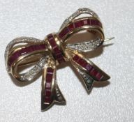 A 9ct gold ruby and diamond set ribbon bow brooch, 27mm.