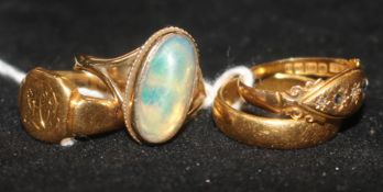 An 18ct signet ring, a 22ct gold band, an 18ct diamond chip ring and a 9ct opal ring.