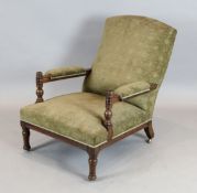 An Aesthetic movement oak armchair, in the manner of E.W. Godwin, with ring turned and fluted frame,