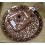 A Newlyn copper candle holder and a similar tray