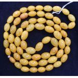 A single strand oval amber bead necklace, gross 49 grams, 92cm.