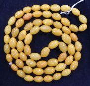 A single strand oval amber bead necklace, gross 49 grams, 92cm.