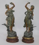 A pair of painted spelter figures "Melody and Poetry"