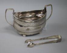 A George III Irish silver sugar bowl and a pair of silver plated sugar tongs.