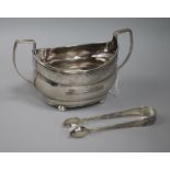 A George III Irish silver sugar bowl and a pair of silver plated sugar tongs.