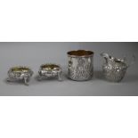 A silver mug, a pair of Victorian silver bun salts and a silver cream jug.