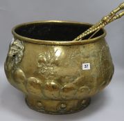 A 19th century embossed brass half lobed compressed drum jardinière, with lion mask ring handles and