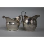 Two George III silver helmet shaped cream jugs, London, 1803 & 1806.