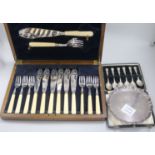 A George V silver waiter, a cased set of six silver spoons and a cased set of plated fish eaters