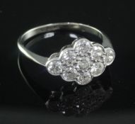 An 18ct gold, platinum and nine stone diamond cluster ring, of marquise shape, size Q.