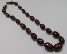 A single strand graduated simulated cherry amber bead necklace, gross 125 grams, 61cm.