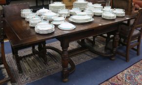 A 1920s's oak draw leaf dining table, W.216cm fully extended