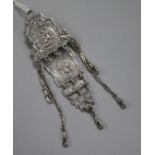 A white metal chatelaine, with four graduating panels, (no accessories).