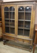 A carved oak bookcase W.107cm