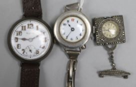 An early 20th century silver manual wind wrist watch in Rolex case and two wrist watches.