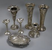 Two pairs of silver vases, one other vase, a silver candlestick and a silver dish.