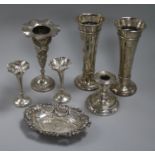 Two pairs of silver vases, one other vase, a silver candlestick and a silver dish.