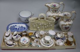 A Belleek basket, two 19th century flower-decorated jugs and a quantity of miniature tableware