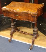 A Victorian walnut games/sewing table, W.66cm