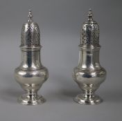 A pair of George II silver sugar casters by Samuel Wood, London, 1744, (a.f.), 14.8cm.