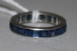 A platinum and sapphire set full eternity ring, size M.