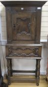 A 17th century style oak cabinet on stand, H.157cm