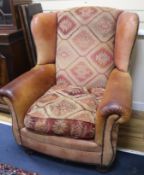 A pair of leather wingback armchairs