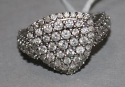 A 9ct white gold and pave set diamond shield shape ring, with diamond set shoulders, size P/Q.