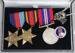 A group of medals, badge and lapel badge
