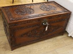 A Chinese relief carved camphorwood chest, W.104cm