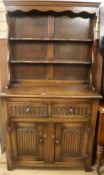 An oak dresser with linen fold carved panels W.96cm