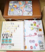 A suitcase of loose stamps and five albums of stamps
