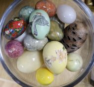 A quantity of eggs in a glass pedestal vase