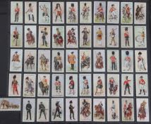 Three folio albums of cigarette cards on Military themes, including Uniforms, Badges, Flags, Medals,