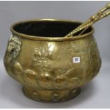 A 19th century embossed brass half lobed compressed drum jardinière, with lion mask ring handles and