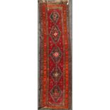 A Karabagh red ground runner c.1910, with five central stepped medallions and three row foliate