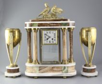 Louis Carvin. An Art Deco bronze and marble clock garniture, comprising four glass clock and pair of