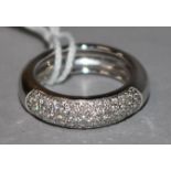 A modern 18ct white gold and pave set diamond half hoop ring, size N.