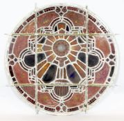 A set of eleven 19th century stained glass roundels, mostly foliate designs, one depicting a dove