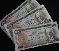 Three Canada one hundred dollar bills, Crow-Bouey, 1975, prefixes AJL,AJM & AJK.