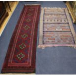 A red ground rug and another 250 x 62cm, 150 x 94cm