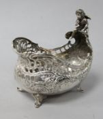 An early 20th century German silver boat shaped bowl with cherub surmount, import marks for