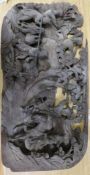 A Chinese wooden panel carved in high relief with a hunting party in a landscape, 29 x 58cm