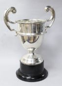 A George V silver two handled trophy cup, Birmingham, 1913, on ebonised socle, overall 28.5cm.