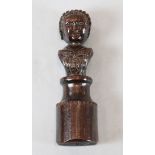 A 17th century carved oak newel post finial of a woman, on circular plinth, 11in.