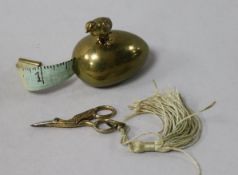 A brass egg and partridge sewing measure and miniature scissors
